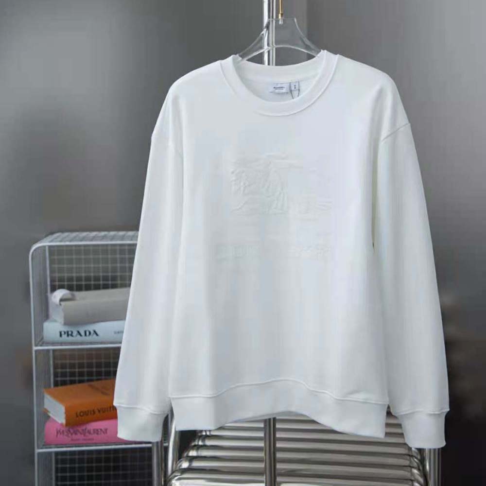 Close-up of embroidered Burberry logo on white sweatshirt chest