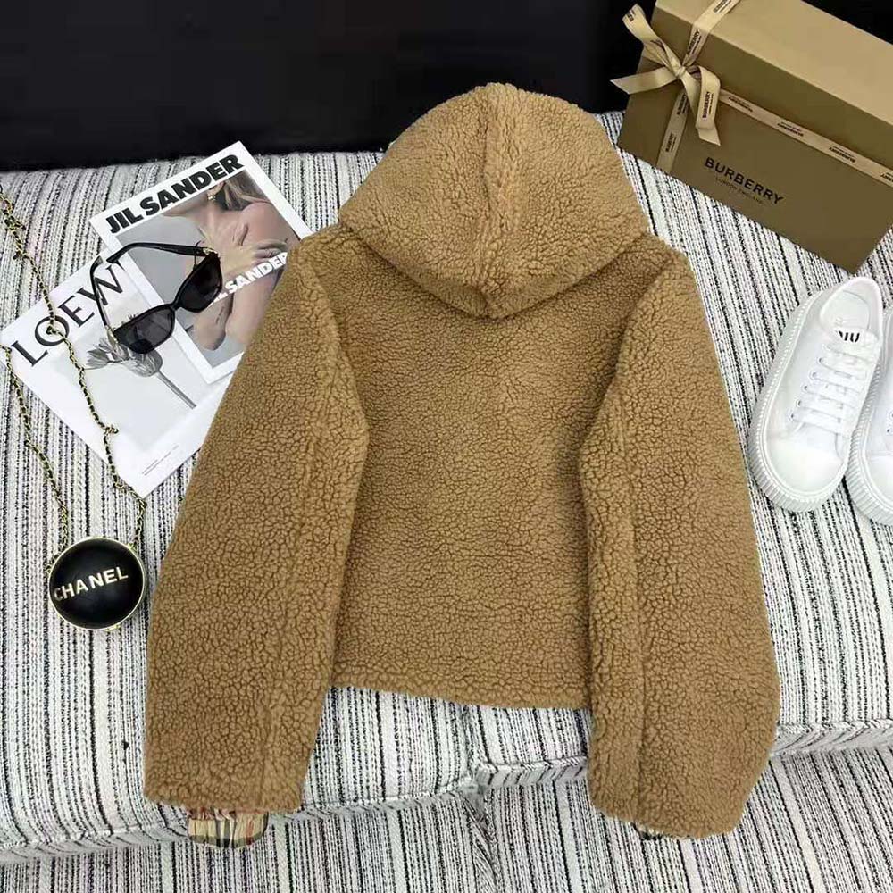 Close-up of Burberry signature hardware on the brown fleece hooded jacket