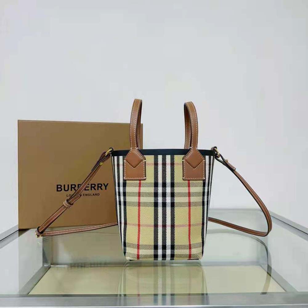 Close-up of gold hardware and check lining inside Burberry Mini London Tote