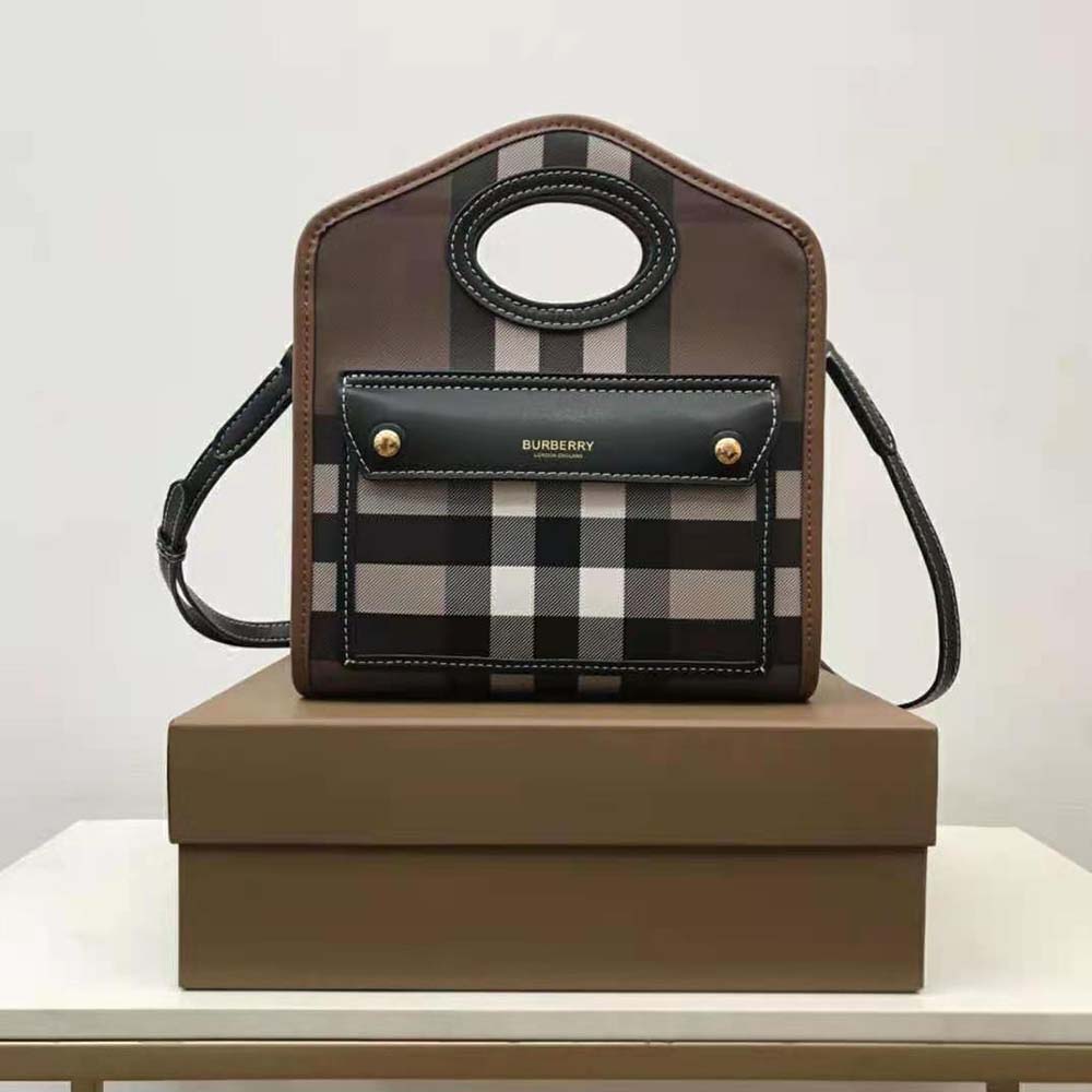 Close-up of smooth leather and Burberry check lining detail inside bag