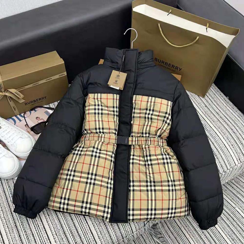 Close-up of signature Burberry hardware on reversible down puffer jacket
