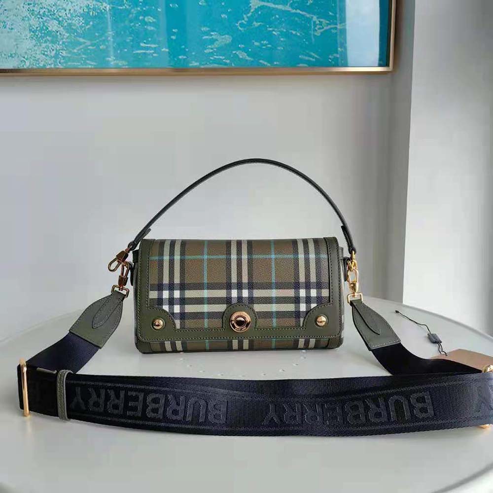 Close-up of Burberry Women Top Handle Note Bag-Green gold-tone clasp detail