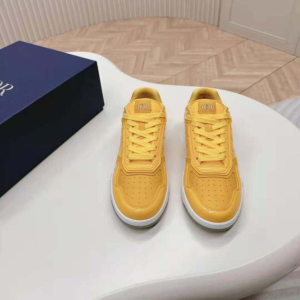 Close-up of yellow patent calfskin and Dior Oblique Gravity leather detail