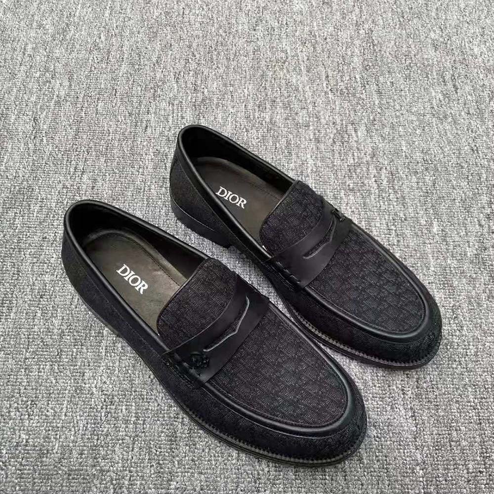 Close-up of blue jacquard fabric and black hardware on Dior Men Granville Loafer