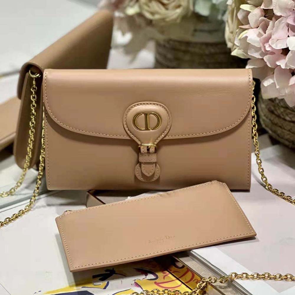 Close-up of gold-tone hardware and smooth calfskin on Dior pouch