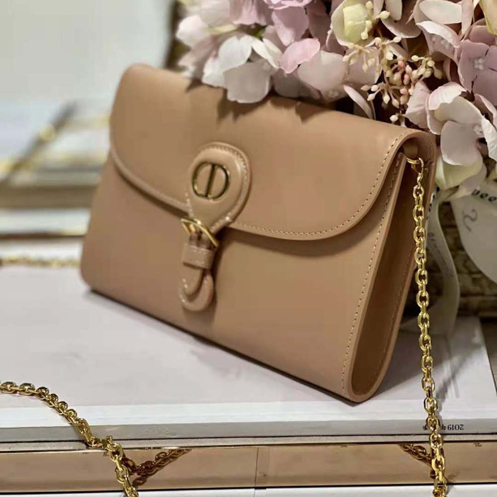 Side angle showing chain strap and compact shape of Dior Bobby pouch