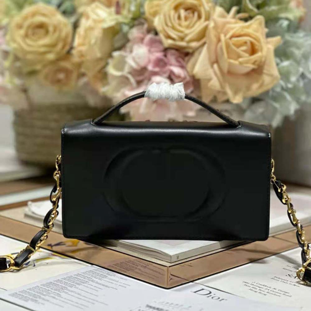 Close-up of embossed CD signature detail on black calfskin Dior bag