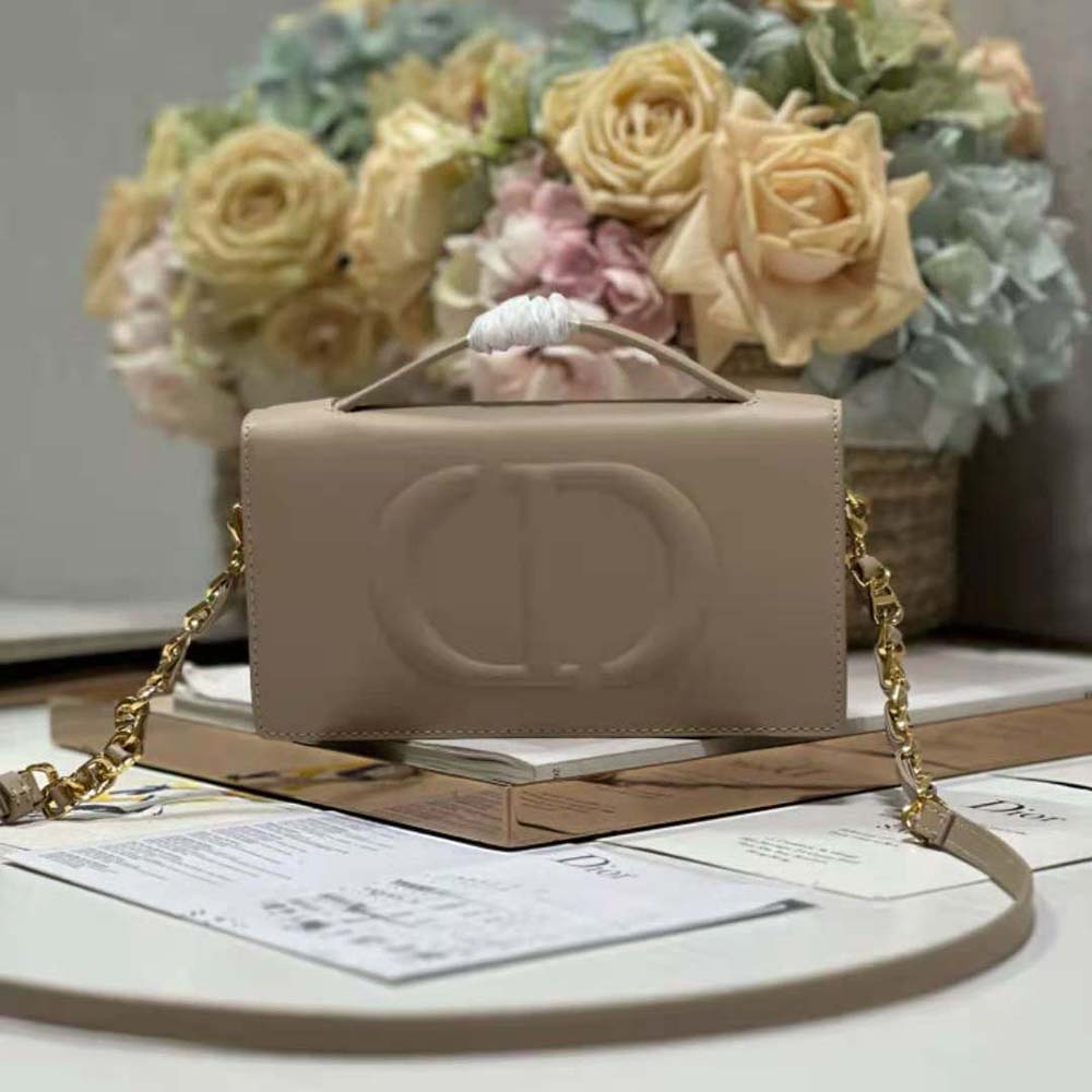 Close-up of embossed CD signature hardware on the mini bag
