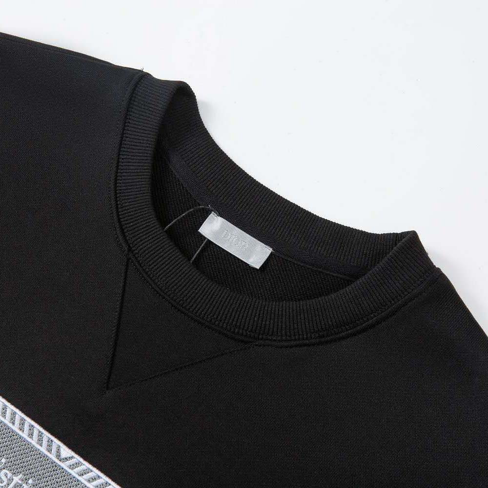 Side angle showing ribbed cuffs on Dior Men black fleece sweatshirt