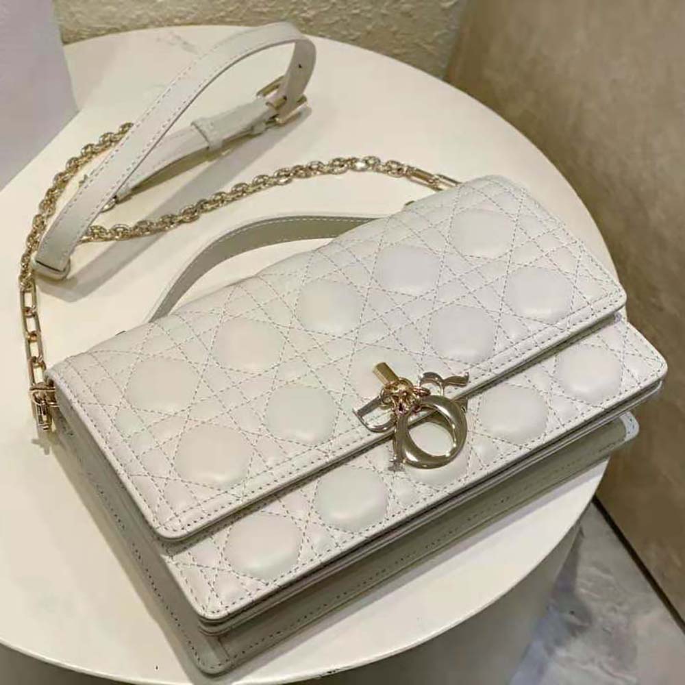 Close-up on cannage stitching and gold hardware of Dior Women Miss Dior Top Handle Bag