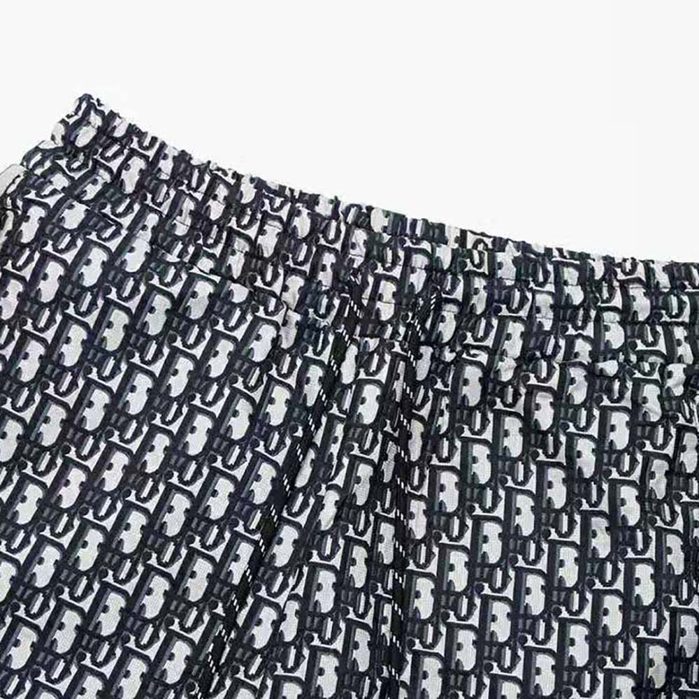 Side angle highlighting the smooth silk twill fabric of Dior Men Oblique Bermuda Shorts