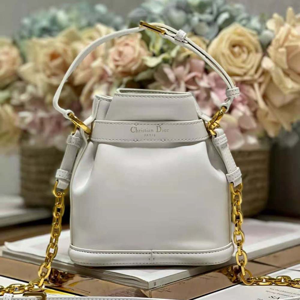 Side profile showing compact silhouette of Dior Women Small C’est Dior Bag Latte