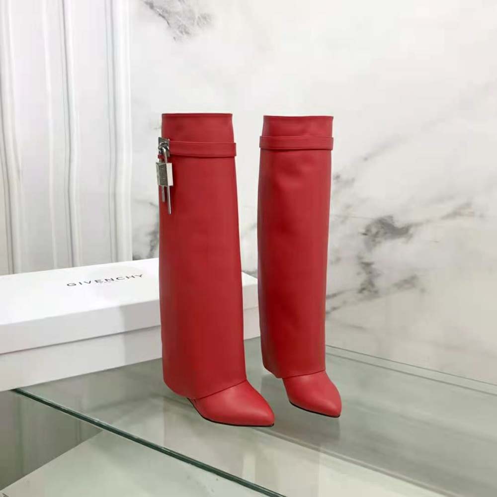 Close-up detail of shark lock hardware on Givenchy red leather boots