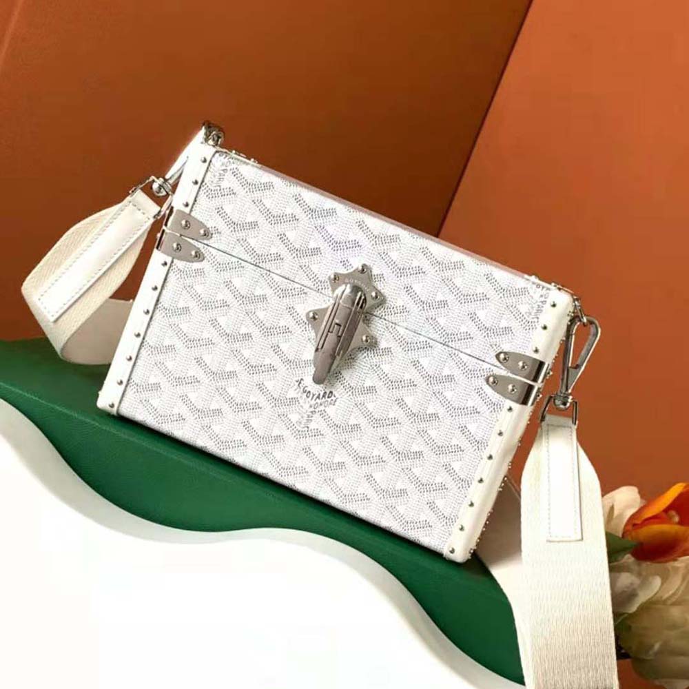 Close-up detail of white Clamecy cowhide and silver hardware on Goyard bag