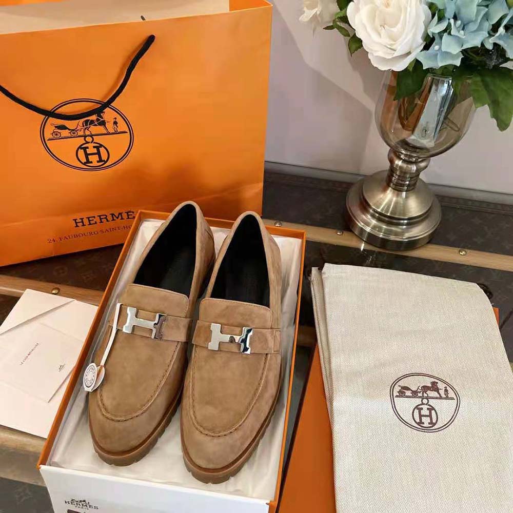 Close-up detail of signature hardware on Hermes Women Faubourg Loafer