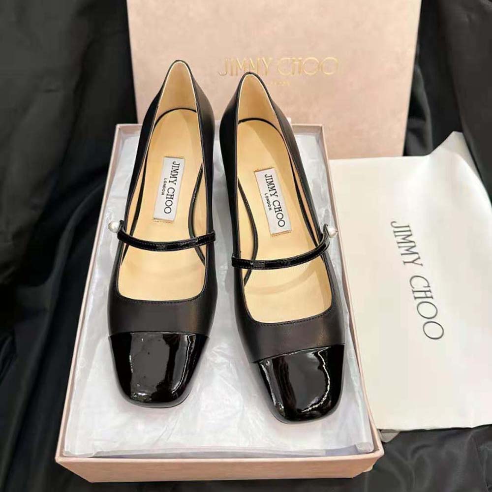 Close-up of patent leather and gold logo on Jimmy Choo Elisa 45 pumps