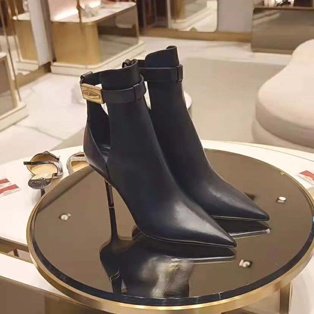 Close-up on embossed hardware detail of Jimmy Choo Women Nell Boot