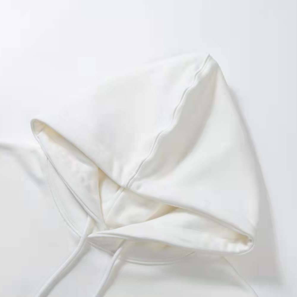 Close-up of Loewe logo embroidery on white cotton hoodie