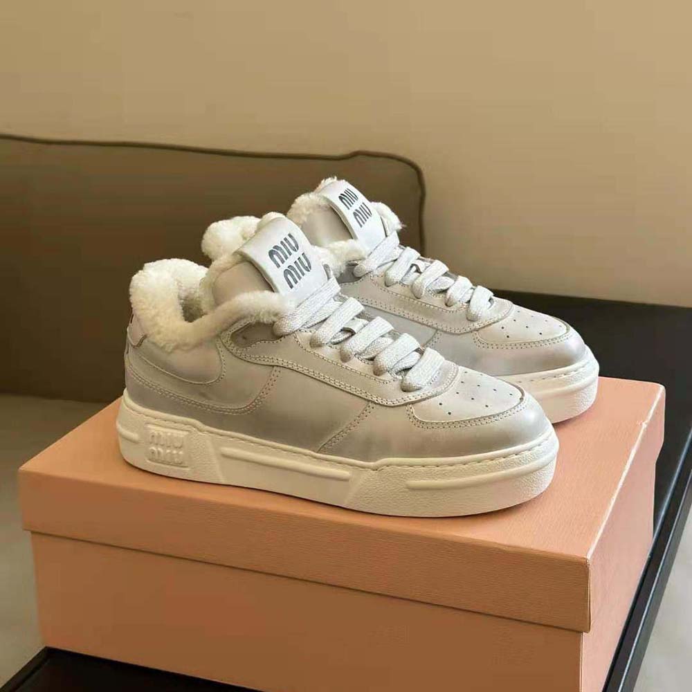 Top-down view highlighting white EVA sole and embossed logo on Miu Miu sneakers