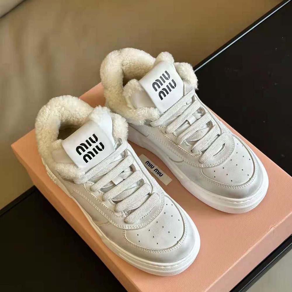 Close-up of bleached leather texture and lace-up detail on Miu Miu sneakers