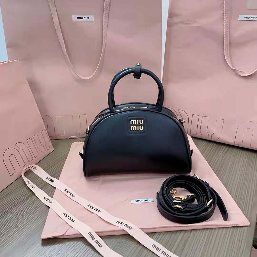 Close-up of silver-tone hardware on Miu Miu leather bag