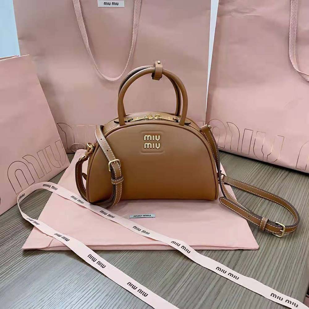 Side angle showcasing structured silhouette of Miu Miu leather bag