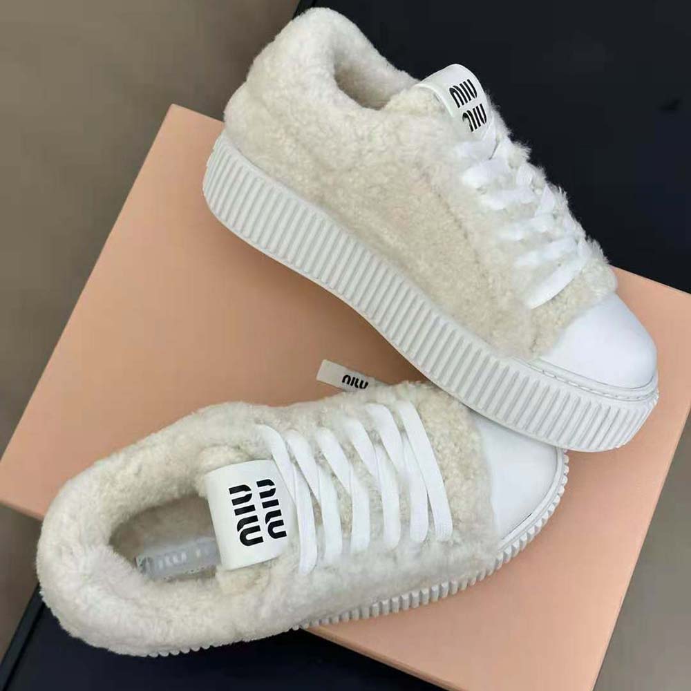 Top view showing lace closure and plush shearling on Miu Miu sneakers