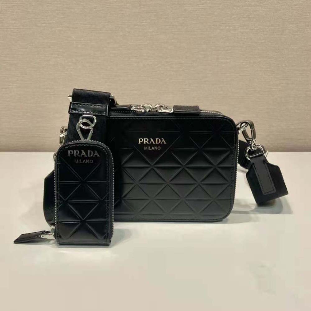 Close-up of brushed leather texture and Prada triangle motif detail