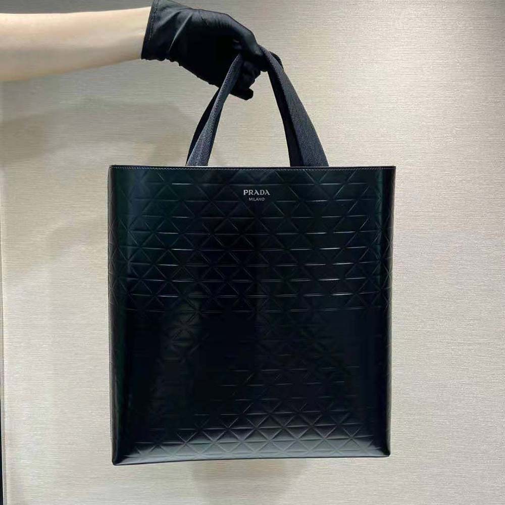 Close-up detail of brushed leather and silver hardware on Prada tote