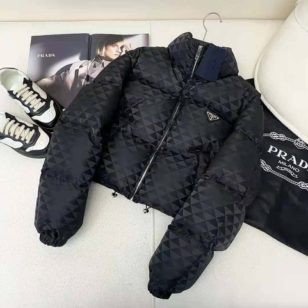 Close-up of black Re-Nylon fabric and branded zipper on Prada jacket