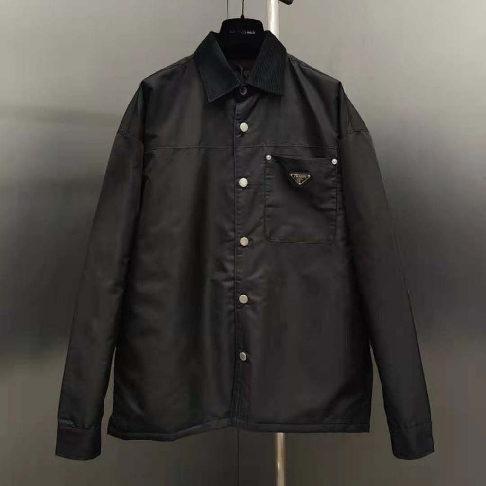 Close-up of Prada triangle logo on black Re-Nylon shirt