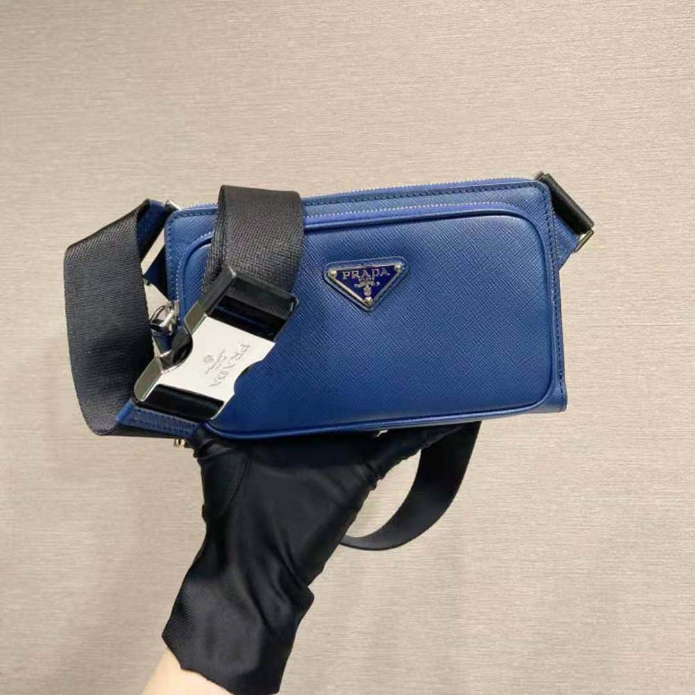 Close-up of Prada logo hardware on the blue leather belt bag