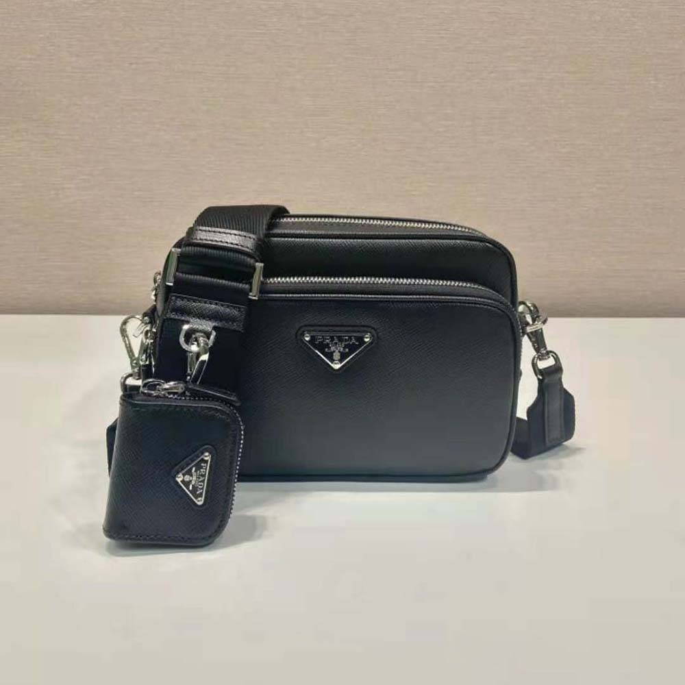 Close-up on silver Prada logo hardware on black Saffiano leather bag