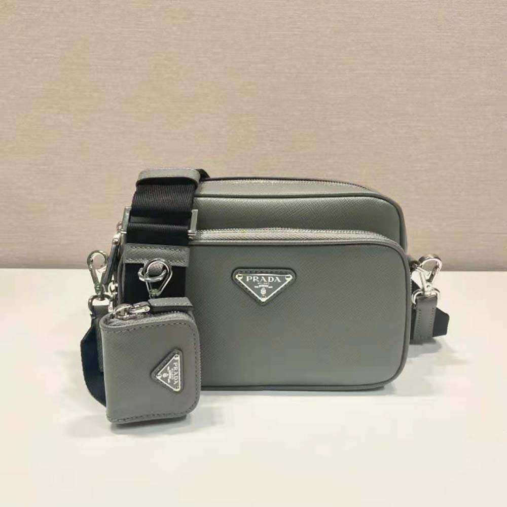 Close-up of silver Prada logo plaque on gray Saffiano leather shoulder bag