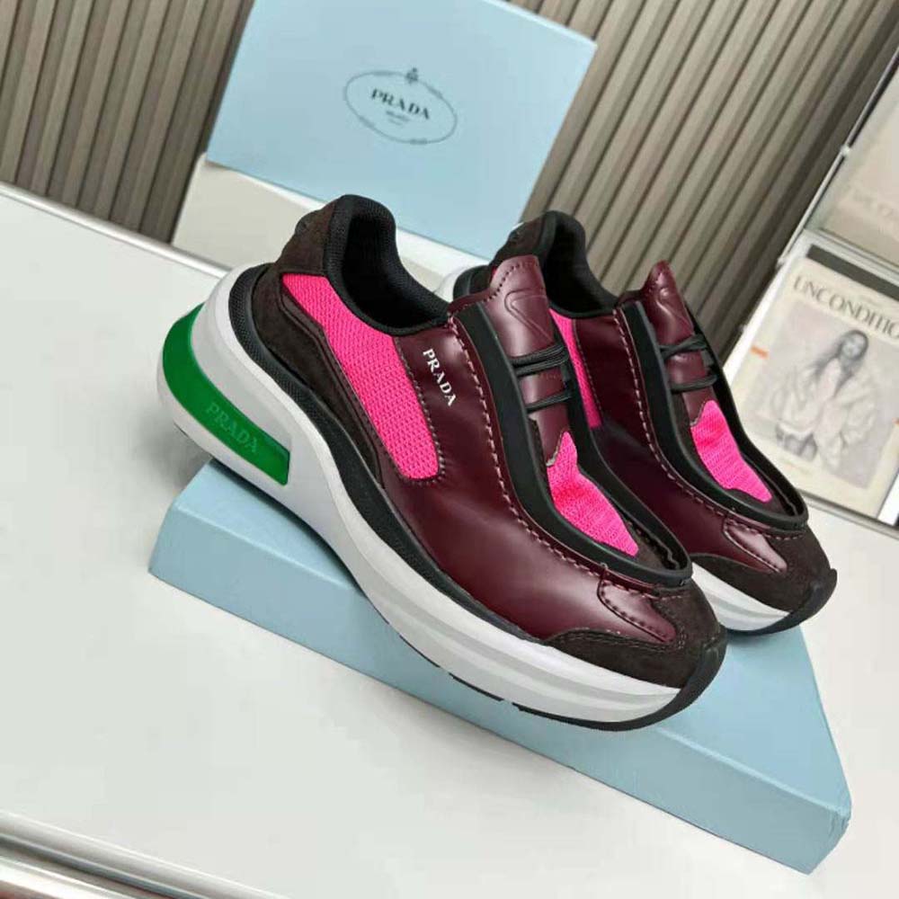 Close-up on lace-up closure and brushed leather of Prada pink sneakers