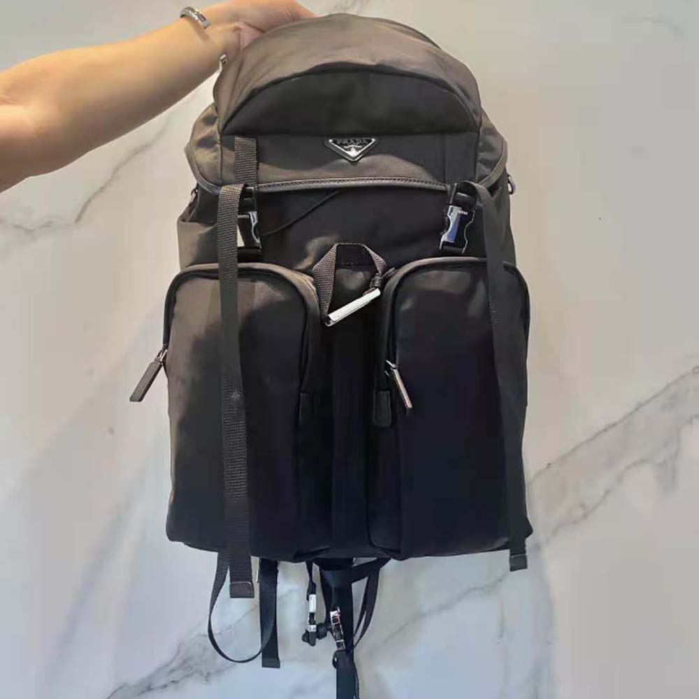 Close-up of the triangle logo detail on Prada Unisex Re-Nylon and Saffiano Leather Backpack