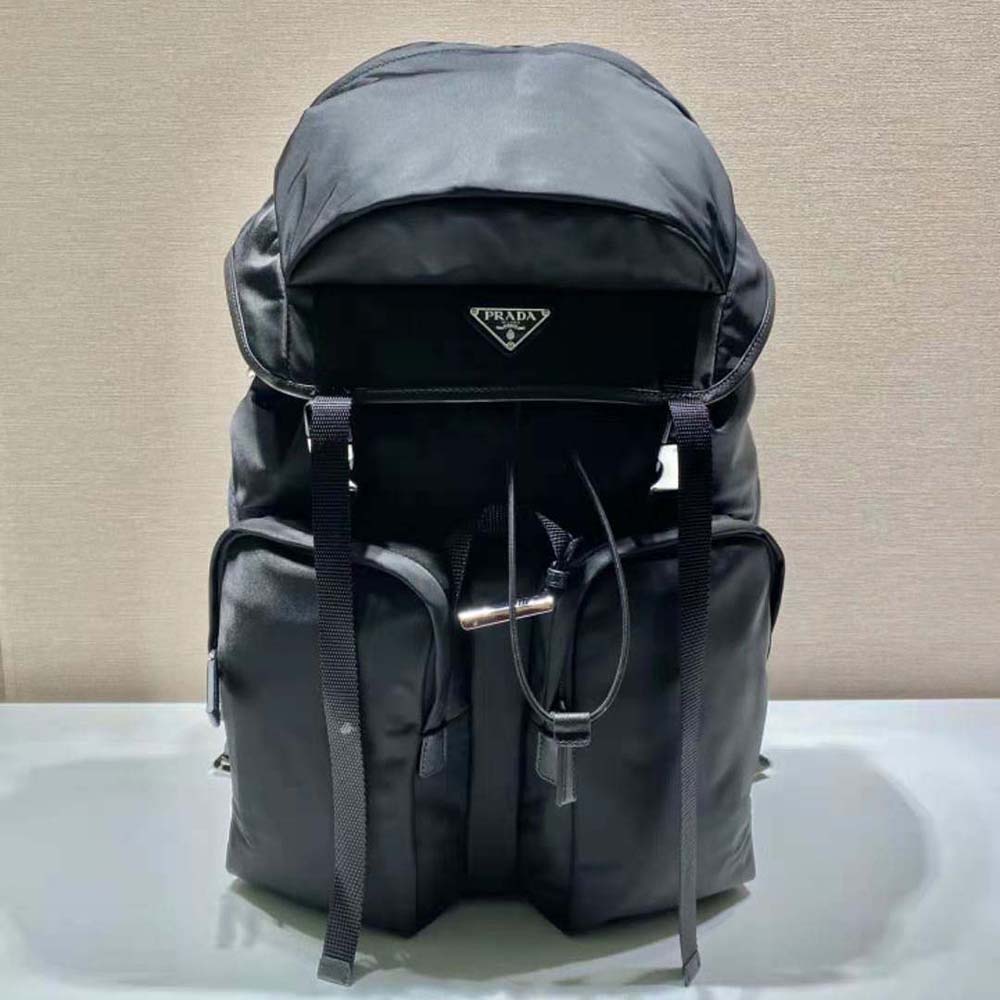 Side angle showing silver-tone hardware and zip closure on Prada Re-Nylon backpack