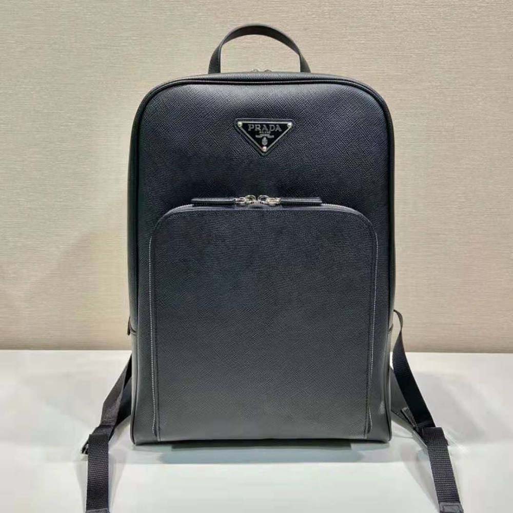 Close-up of Prada triangle logo on black saffiano leather backpack