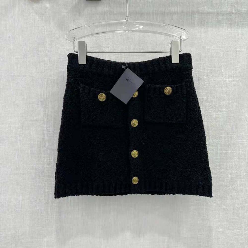 Close-up of Prada signature hardware on black mohair miniskirt