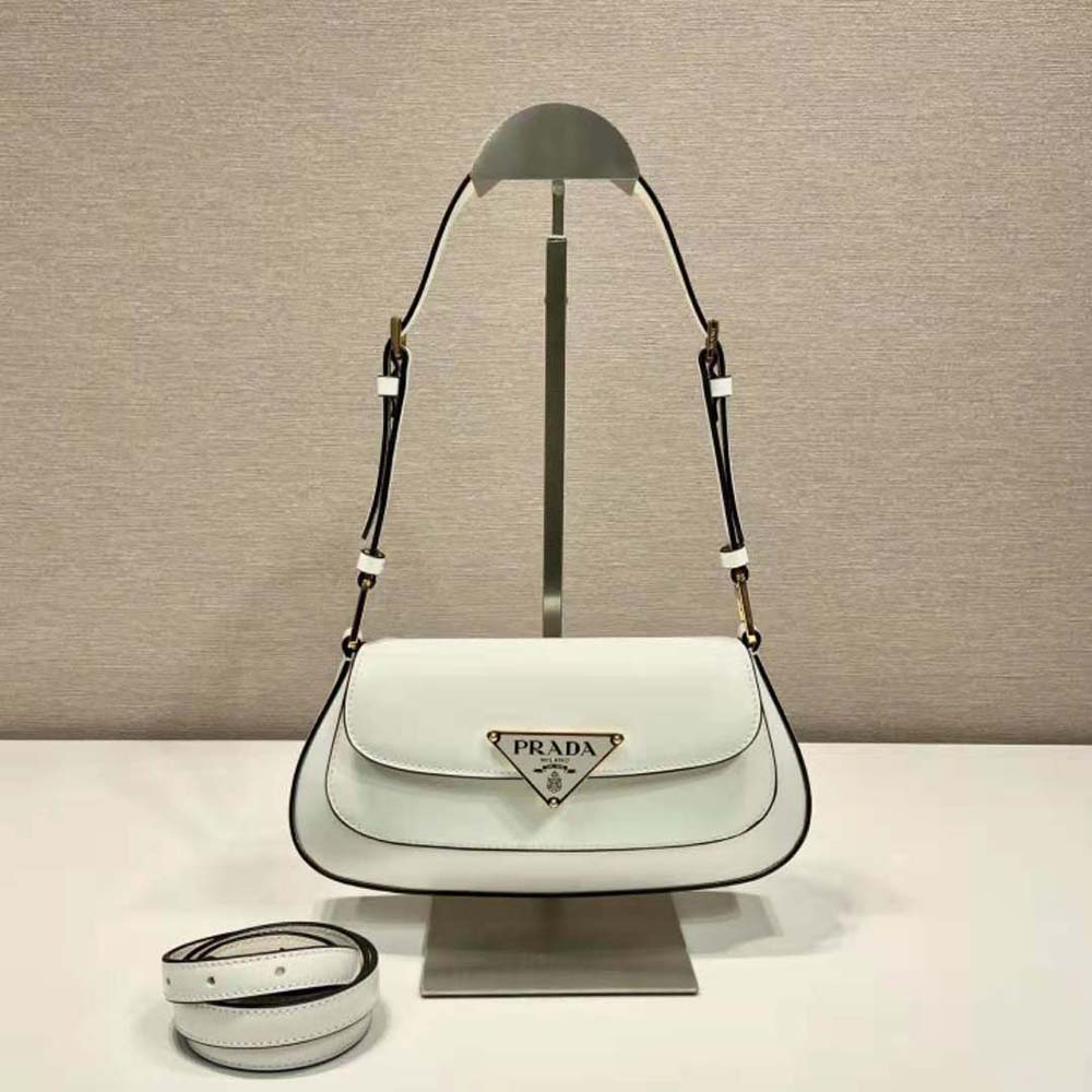 Close-up of silver-tone Prada logo hardware on shoulder bag side