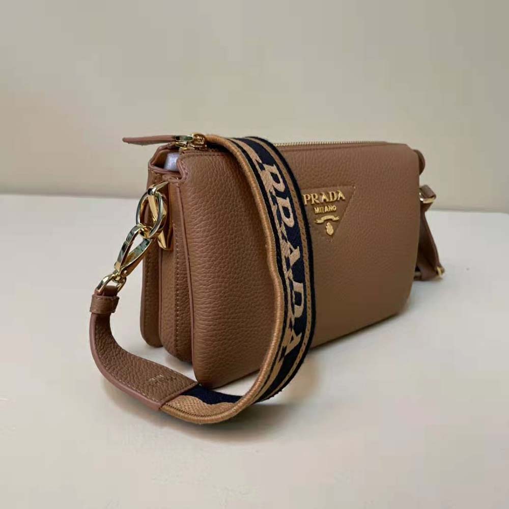 Side angle showing smooth brown leather and zipper closure on Prada bag