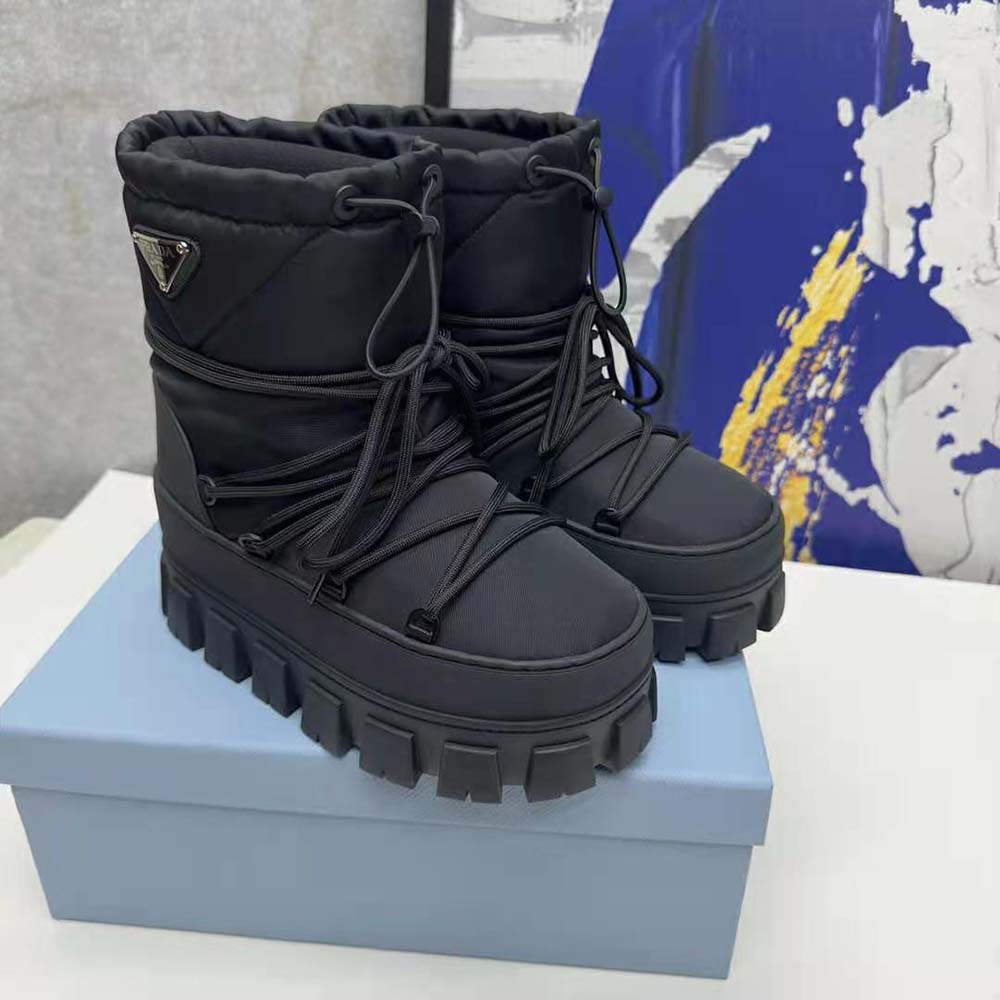 Close-up of Prada branded zipper on black après-ski boots