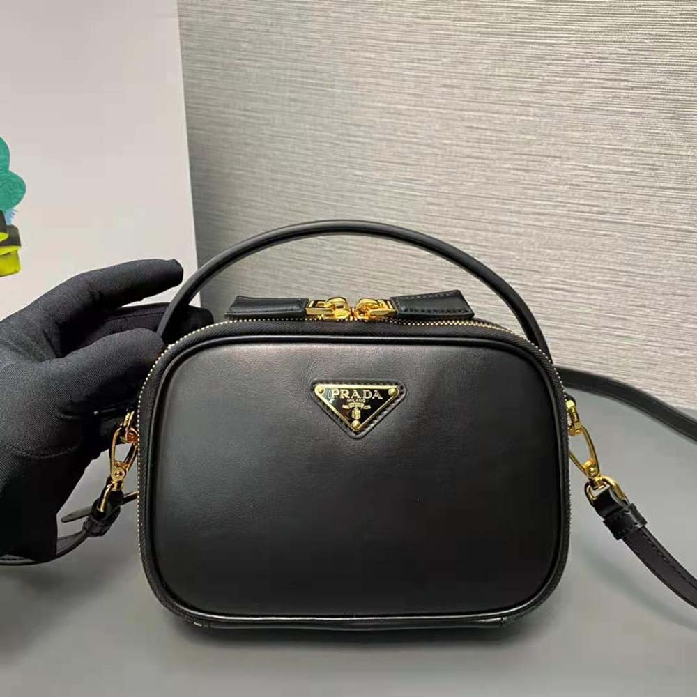 Close-up of smooth calfskin leather and flap closure on Prada mini-bag