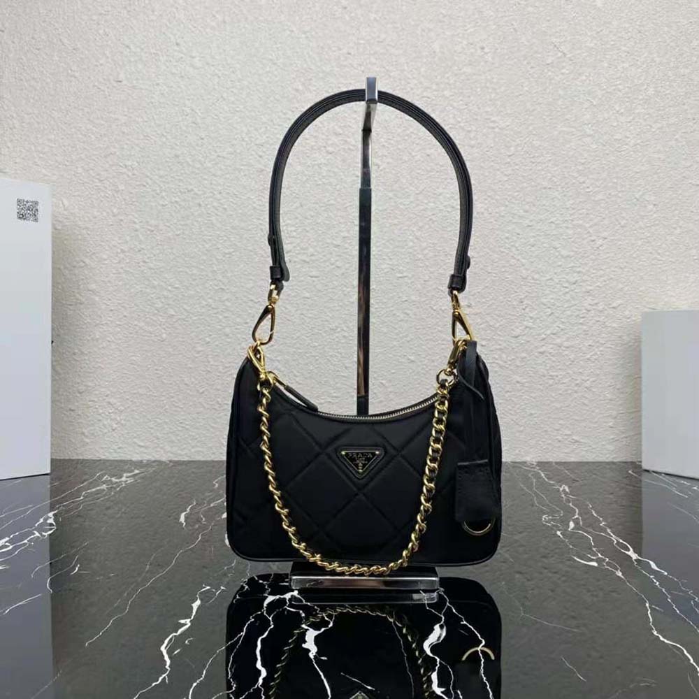 Close-up of silver chain strap and Prada logo on mini-bag
