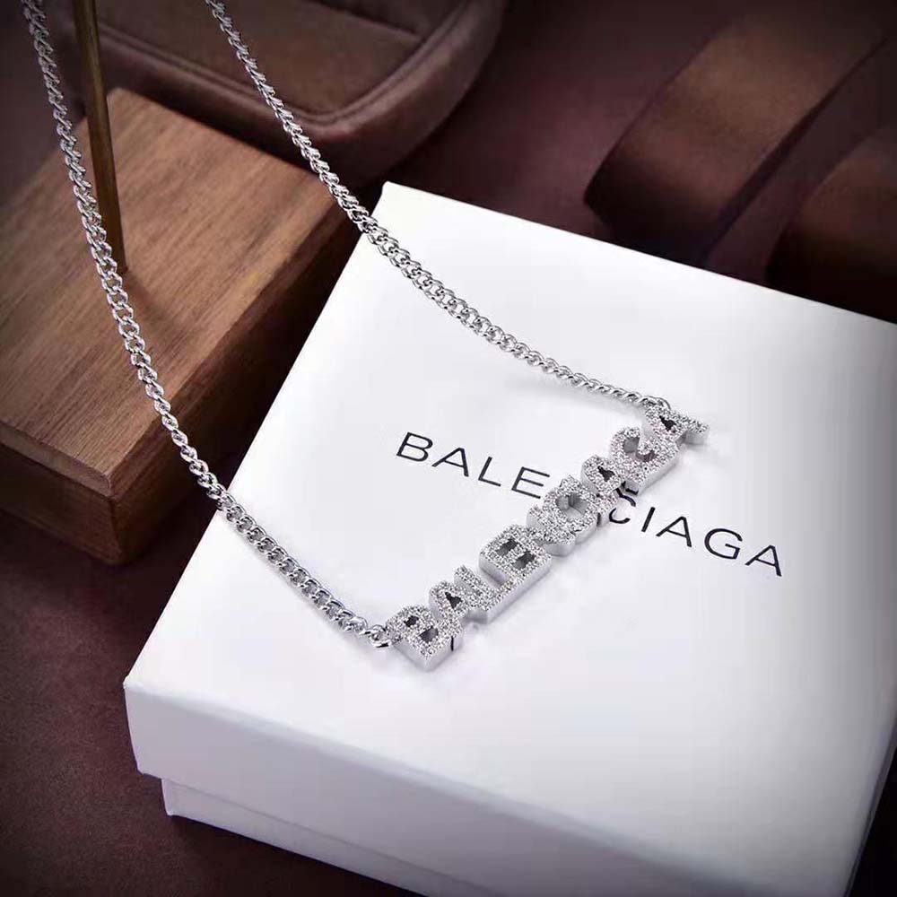 Styled shot of Balenciaga Women Typo Mirror Necklace worn with minimalist outfit