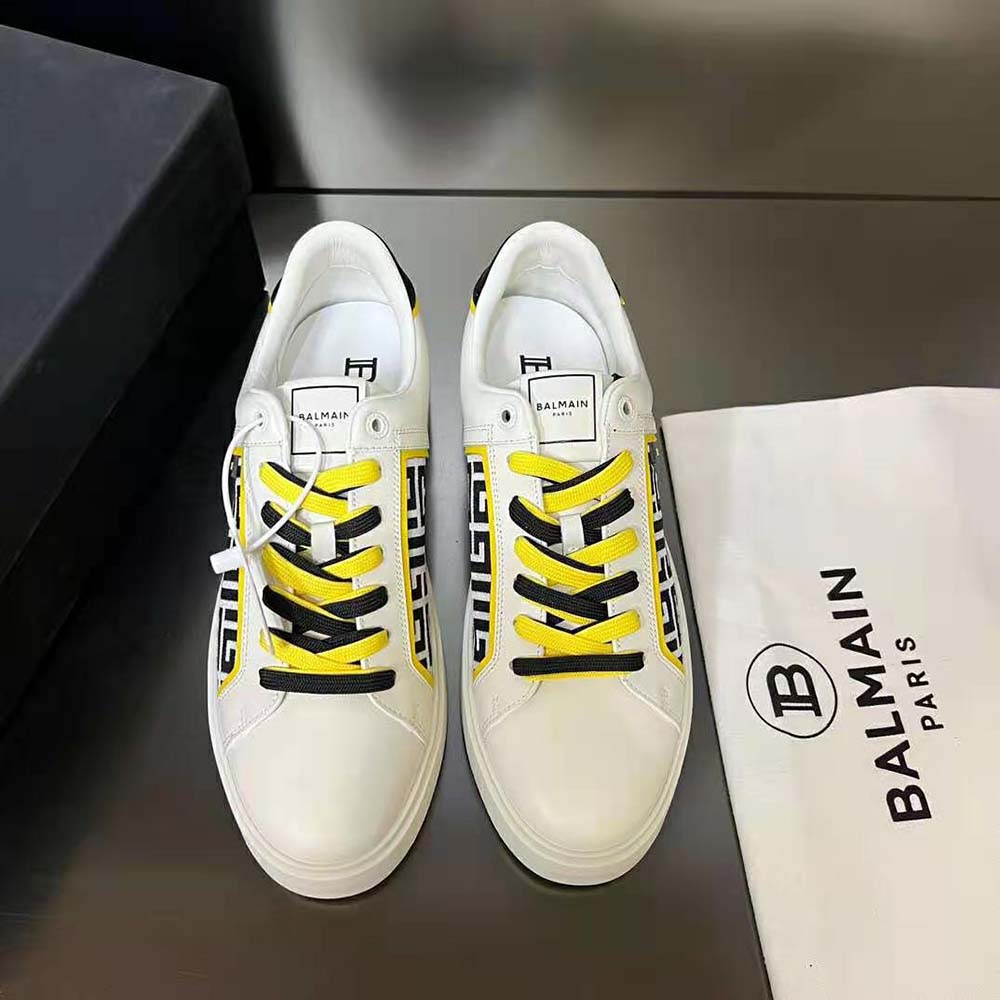 Close-up of embossed Balmain monogram on white leather trainer