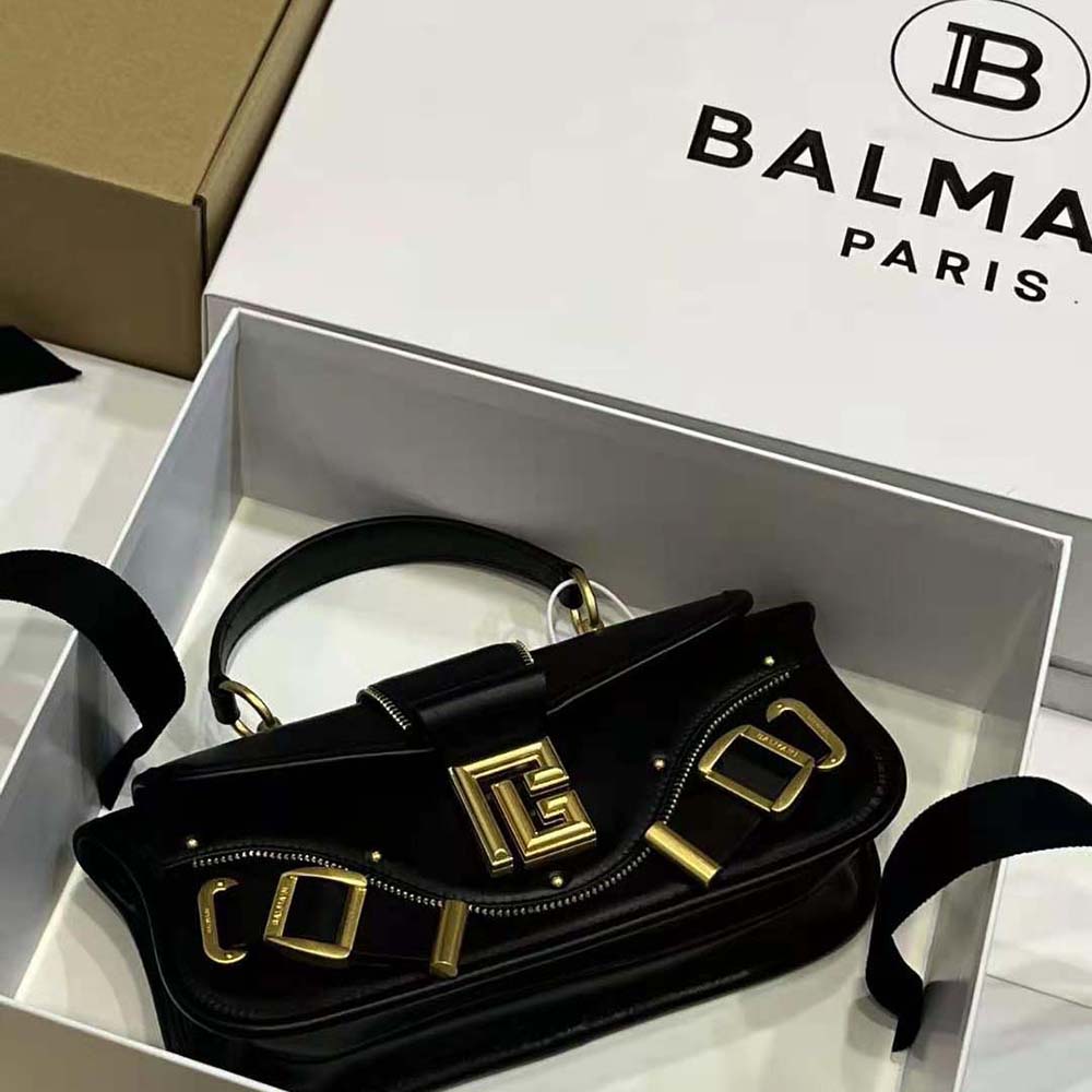 Side angle showing silhouette of Balmain Women Blaze Clutch Bag black leather
