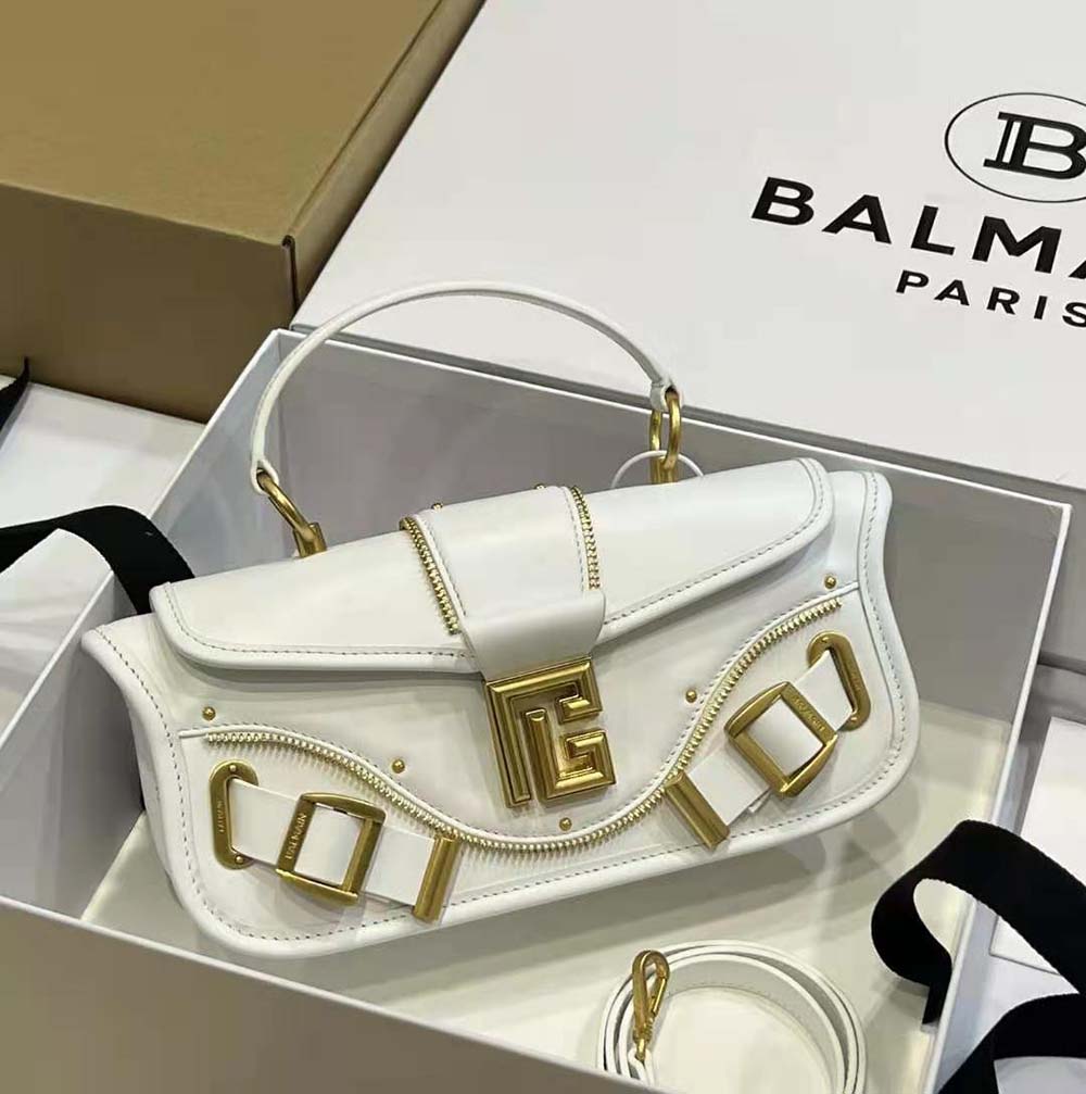 Close-up of signature hardware on Balmain Women Blaze Grained Leather Clutch Bag-White