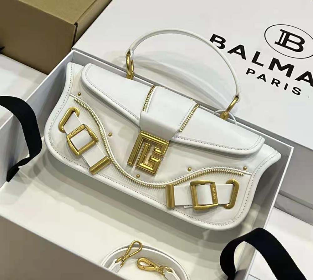 Side angle showcasing slim profile of Balmain Women Blaze Grained Leather Clutch Bag-White