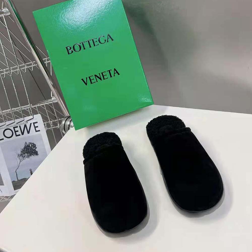 Overhead shot showing textured black calfskin and minimalist silhouette slipper